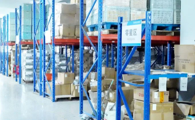 Organized packing materials and cartons on warehouse shelves